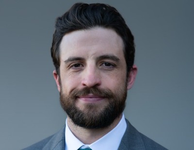 Jackson McCue, bearded with a suit and tie